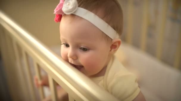 Een klein kind permanent in haar wieg ingedrukt te houden pennen voor reling — Stockvideo