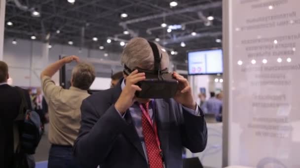 Russia, Novosibirsk, 2015: Solid man looks into a virtual reality glasses — Stock Video