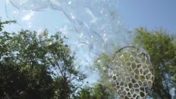 Erzeugen Sie mit dem Gerät eine wunderliche Blase. Blasen fliegen am Himmel. — Stockvideo