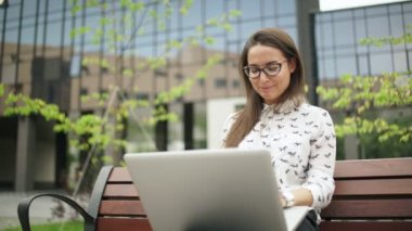 Kız dizüstü ekrana bakar ve klavyede yazarak