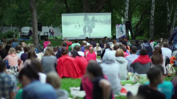 Russia, Novosibirsk, 2016: Showing an open-air movie. The screen — Stock Video