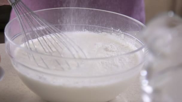 Whisk in glass bowl of raw egg in slow motion. Whisk for whipping — Stock Video