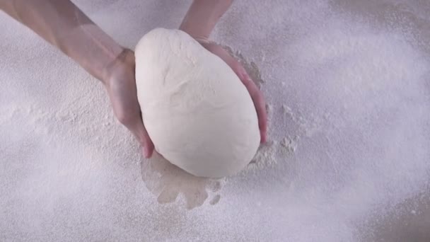 Female hands kneading the dough on the wooden table full of flour — Stock Video