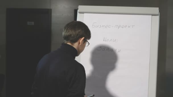 Mladý muž dělat prezentaci o flip-chart. — Stock video
