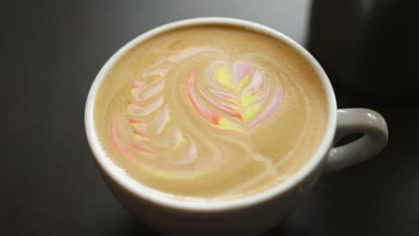 Latte art coffee. Colorful rainbow latte in a white cup. — Stock Video