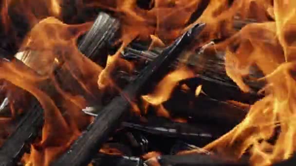 Gros plan de flammes brûlant sur fond noir, au ralenti .