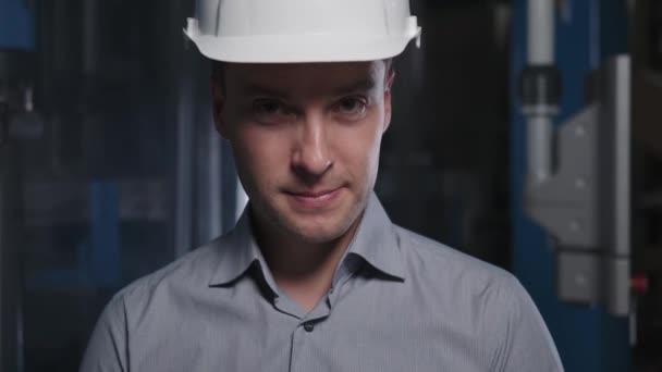 Facial expression of a young engineer in a helmet. He smiles — Stock Video