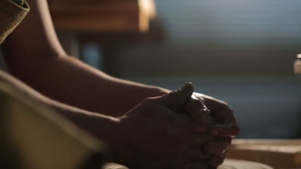 Hands of a potter, creating an earthen jar on the circle — Stock Video