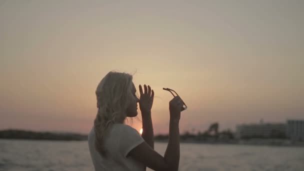 Romantic girl at sunset on the sea background — Stock Video