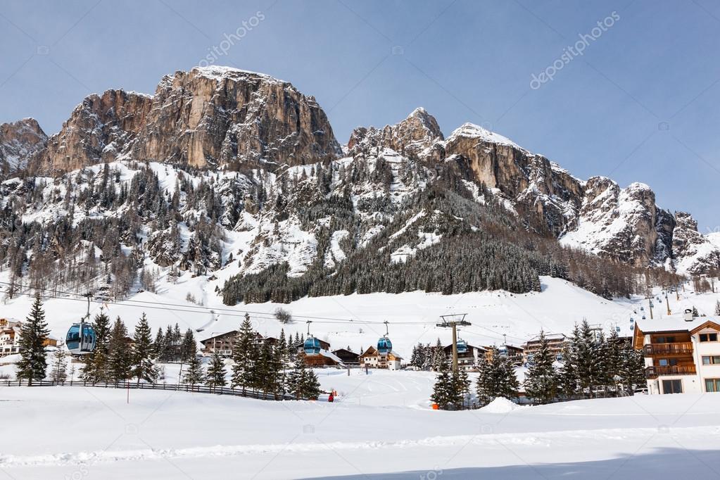View of Colfosco, a mountain village and ski area in the Italian Dolomites, with snow