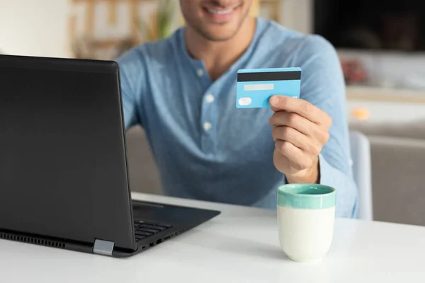 person holding credit card, making internet purchases, online sh