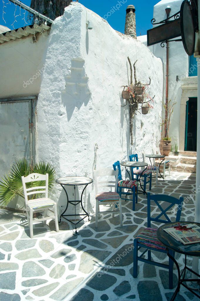 Naxos island, Greece. Historic Kastro with view of small taverna and it's terrace in a quiet corner of the old town.  Authentic, typical Greek island scene.  