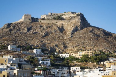Leros, Greece the Castle of Pandeli. Dramatic view of the medieval fortress high on a hill dominating the landscape.  Blue sky and copy space.