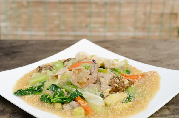 Fried noodle with pork,shrimp and kale soaked in gravy — Stock Photo, Image