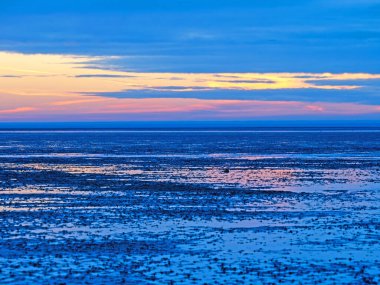 Blue hour in the Lower Saxony Wadden Sea off Cuxhaven Sahlenburg at low tide, Germany clipart