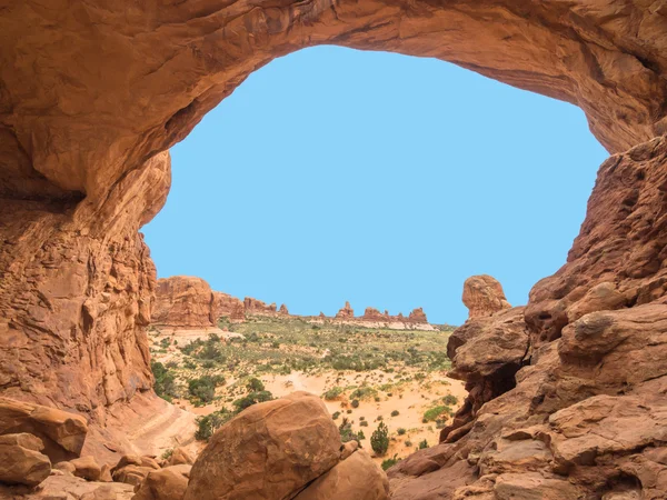 Natural stone arch with space for text in the middle with blue background