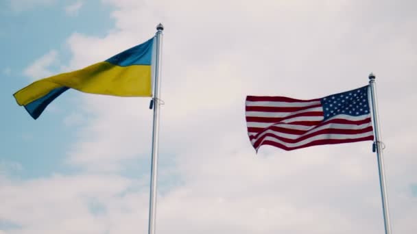 Ukraine and United States flags fluttering in wind — Stock Video