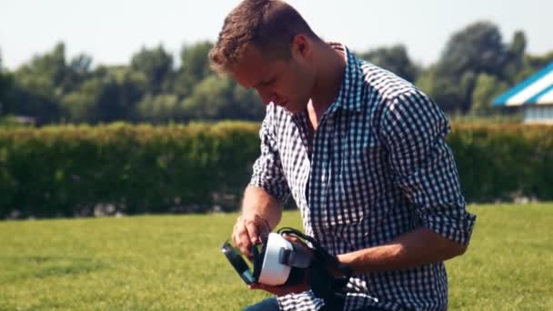 Man in checkered shirt fiddles with appliance — Stock Video