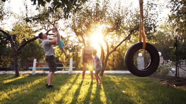 Förälder som leker med barnen hemma med swing — Stockvideo