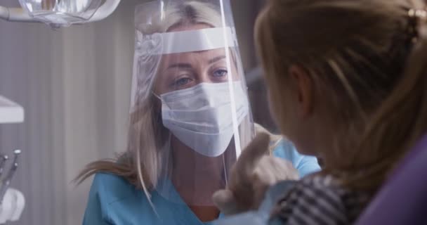 Tandläkare som arbetar med liten flicka — Stockvideo