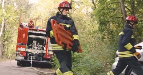 Brandweermannen haasten zich om multi-etnische familie te redden van brandende auto — Stockvideo