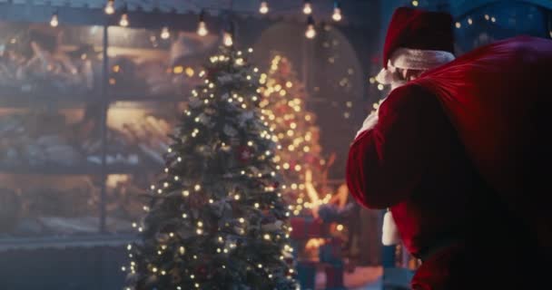 Santa Claus en máscara caminando tranquilamente cerca del árbol de Navidad — Vídeos de Stock
