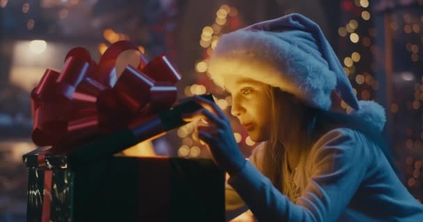 Gelukkig meisje opening magie kerstcadeau — Stockvideo