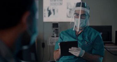 Doktor zatürree belirtileri olan bir hastayla konuşuyor.