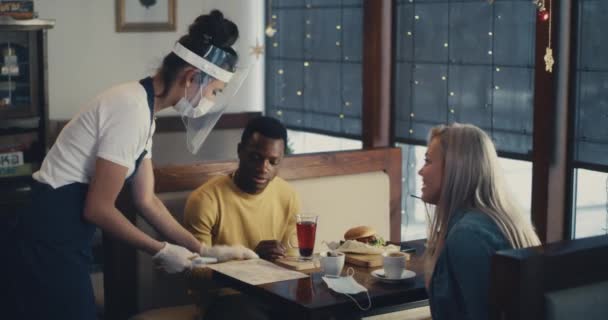 Servírka v sebeobraně sloužící různé páry v kavárně — Stock video