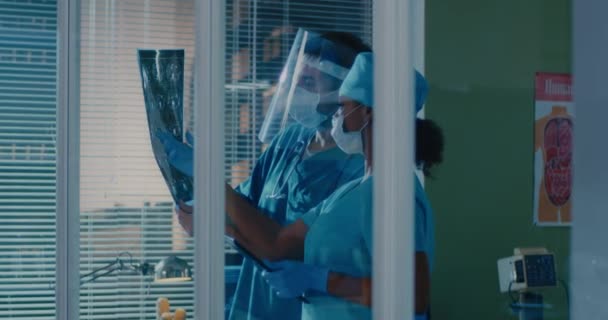 Diverse colleagues examining X ray scan together — Stock Video