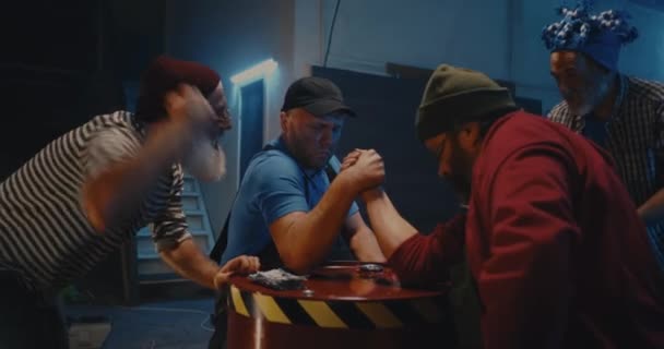 Dospělí muži paže wrestling pro peníze v blízkosti přátel — Stock video