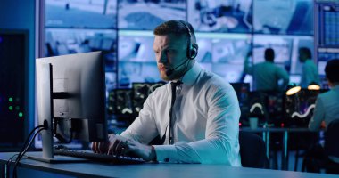 İş yerinde bilgisayar kullanan bir güvenlik görevlisi