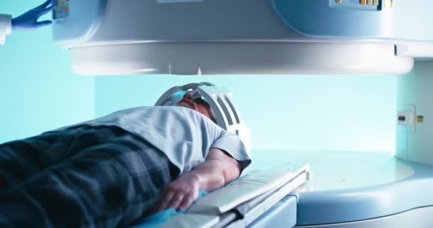 Médico de cosecha con guantes encendiendo el escáner de resonancia magnética para hombre mayor — Vídeos de Stock