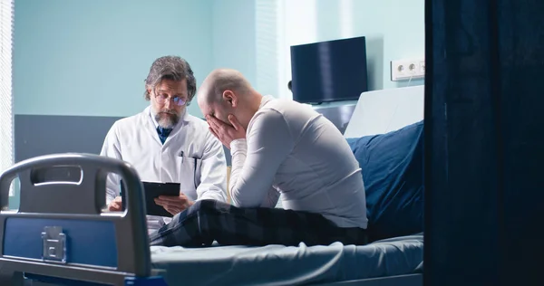 Doctor telling bed news to cancer patient
