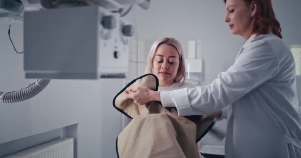 Amistoso médico preparando al paciente para la exploración por rayos X — Vídeos de Stock