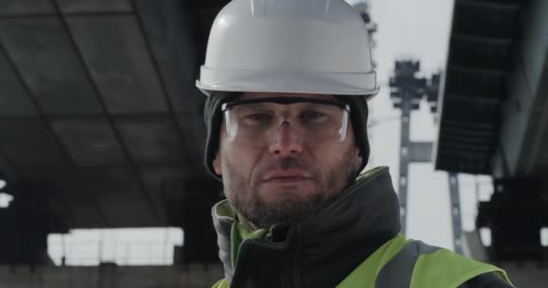 Serious bridge builder looking at camera — Stock Video