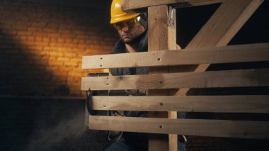 Tahta yapının tahtalarını kesen adam