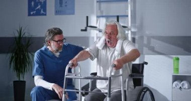 Doktorun yanında yürüyen iskelet kullanan mutlu kıdemli hasta.