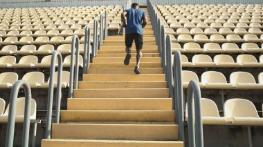 Merdivenlerde koşan isimsiz siyah sporcu