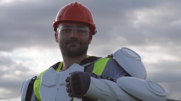 Ingénieur ferme solaire confiant dans l'exosquelette contre ciel nuageux — Video