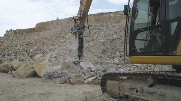 Industrial machinery breaking stone on quarry