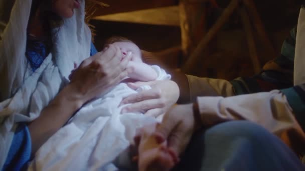 Crop Mary and Joseph caressing baby Jesus — Stock Video