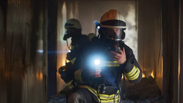 Tűzoltók vizsgálják a folyosót tűz után. — Stock Fotó