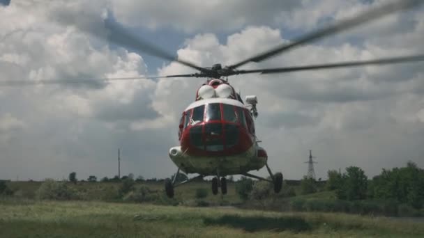Emergency helicopter flying up from field — Stock Video