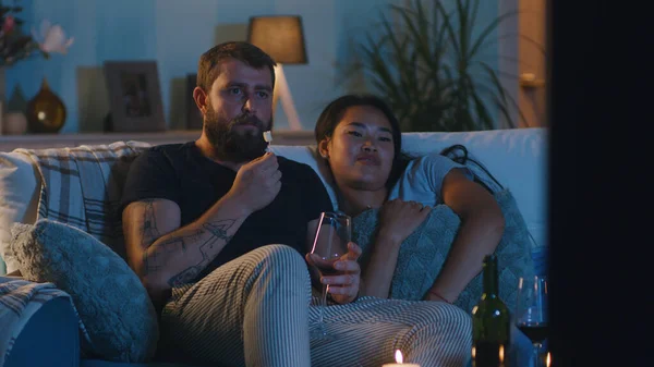 Multiracial couple watching TV during date — Stock Photo, Image