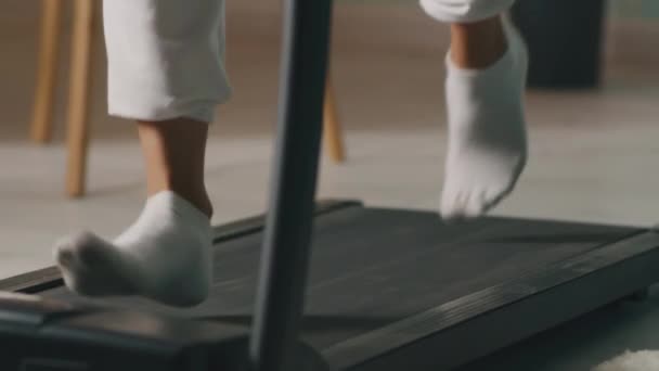 Crop female running on treadmill — Stock Video