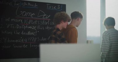 Students Talking After Lecture in Computer Lab. Boys in Sun Filled Classroom Discuss Game Development Projects. Modern Education, Student Lifestyle, Studying Digital Disciplines. Slow Motion.