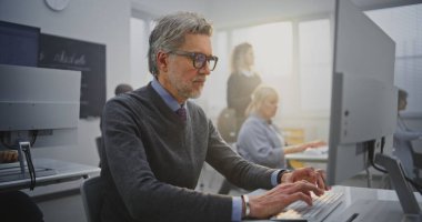 Programlama kursu sırasında Masaüstü Bilgisayarı 'nda Gözlüklü Kıdemli Adam' ı Harekete Geçirin. Sürekli Öğrenme, Modern Eğitim, Teknoloji Müdahalesi ve Kişisel Gelişim kavramını benimseyin. Portre.