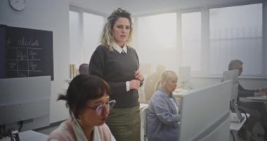 Güvenilir Orta Çağ Kadın Eğitmeni Yetişkin Kadın Öğrenciyi Bilgisayar Laboratuvarında Destekliyor, Programlama Görevlerini Tartışıyor ve Geribildirim Veriyor. Yaşam Boyu Öğrenme, Dijital Edebiyat, Akıl hocalığı.