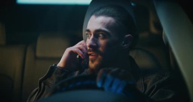 Sürücü koltuğundaki adam duygusal olarak akıllı telefona konuşuyor, hayal kırıklığıyla hareket ediyor ve kişisel anlaşmazlığı çözmeye çalışıyor. İlişki Sorunları, Yanlış Anlama ve Arabada Özel Bir Anda Ham Duygu.